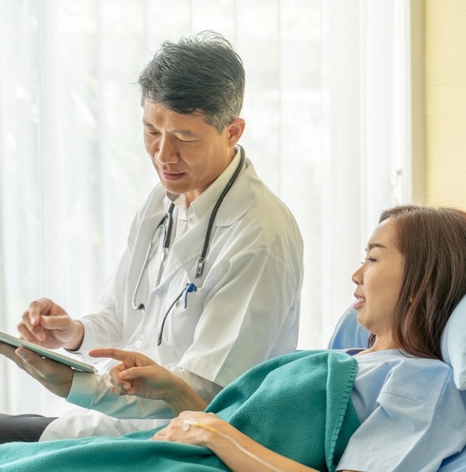 doctor talking to patient in bed about Quitting alcohol cold turkey