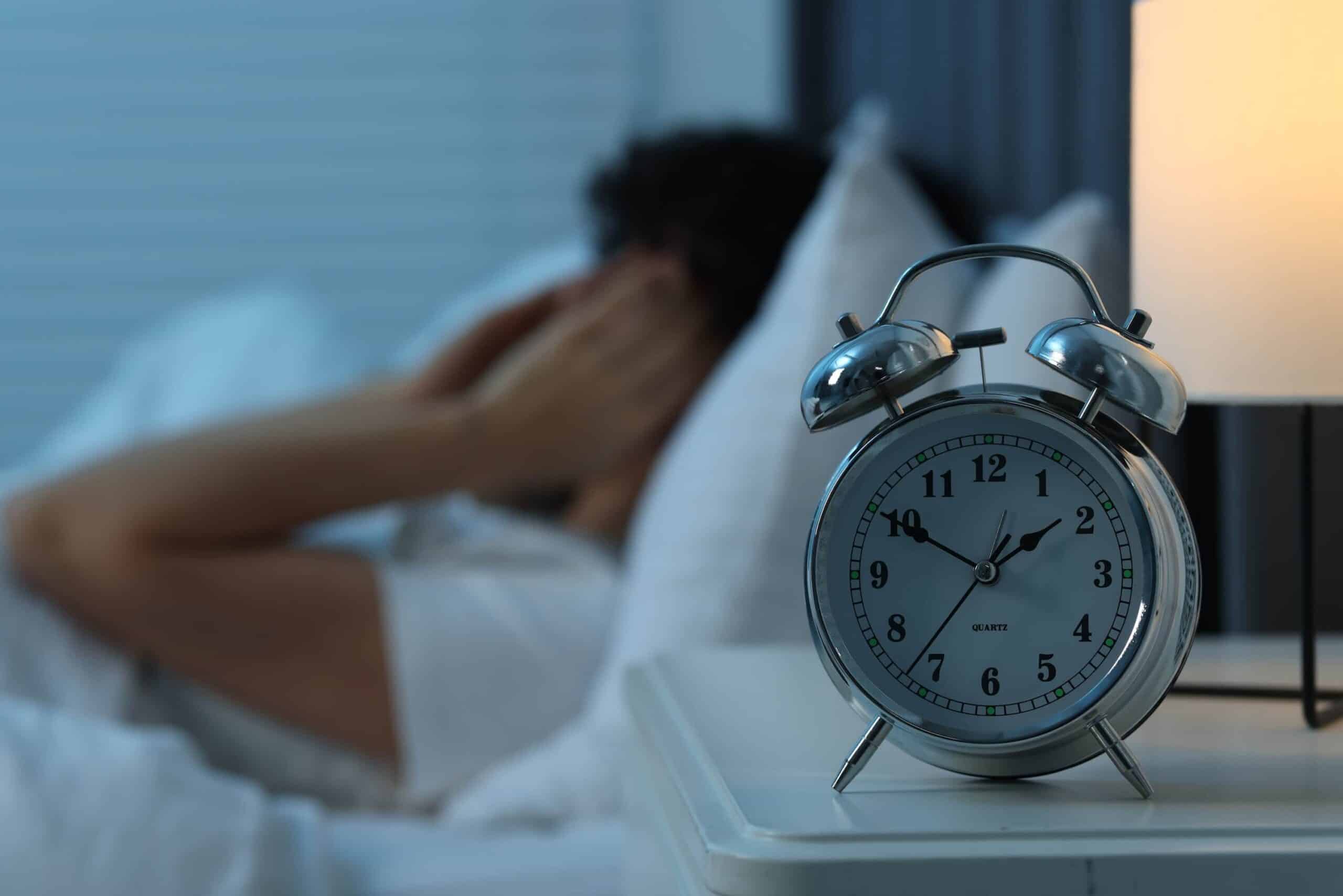 anxious woman in bed wondering how long does heroin stay in your system